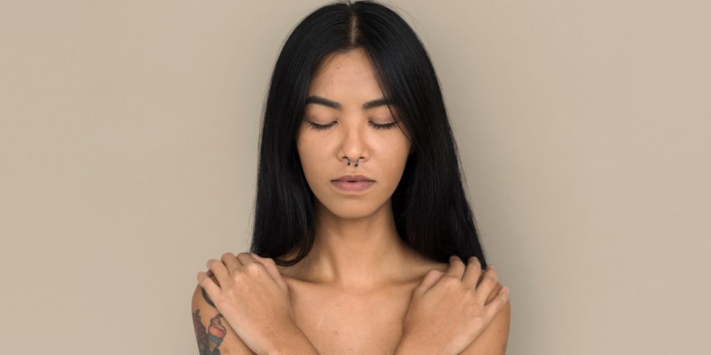 woman septum piercing on brown background