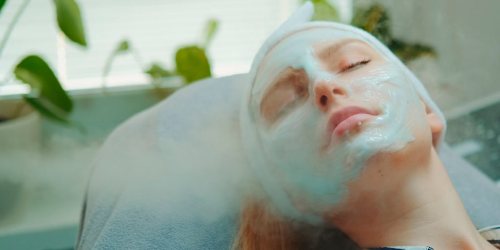 a woman is steaming her face