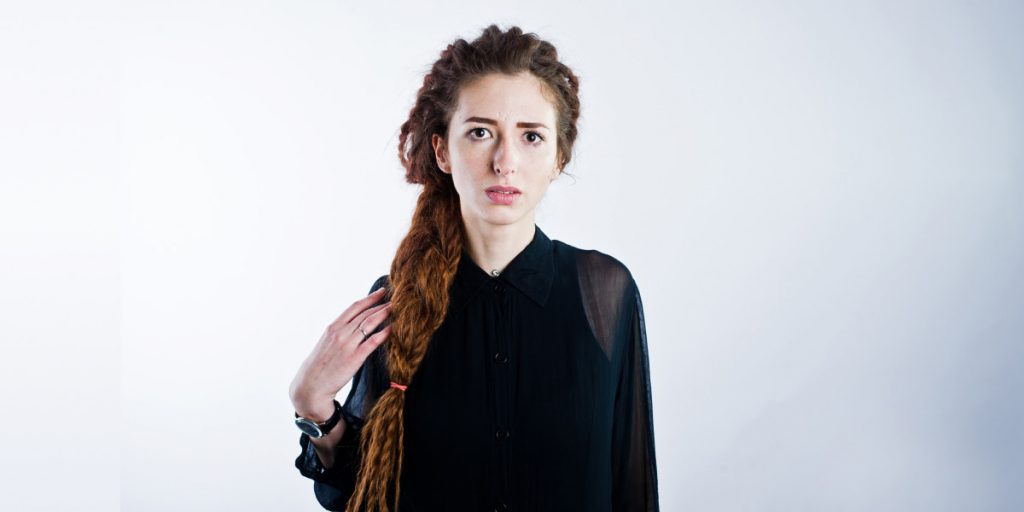 woman with dreadlock looking at the camera