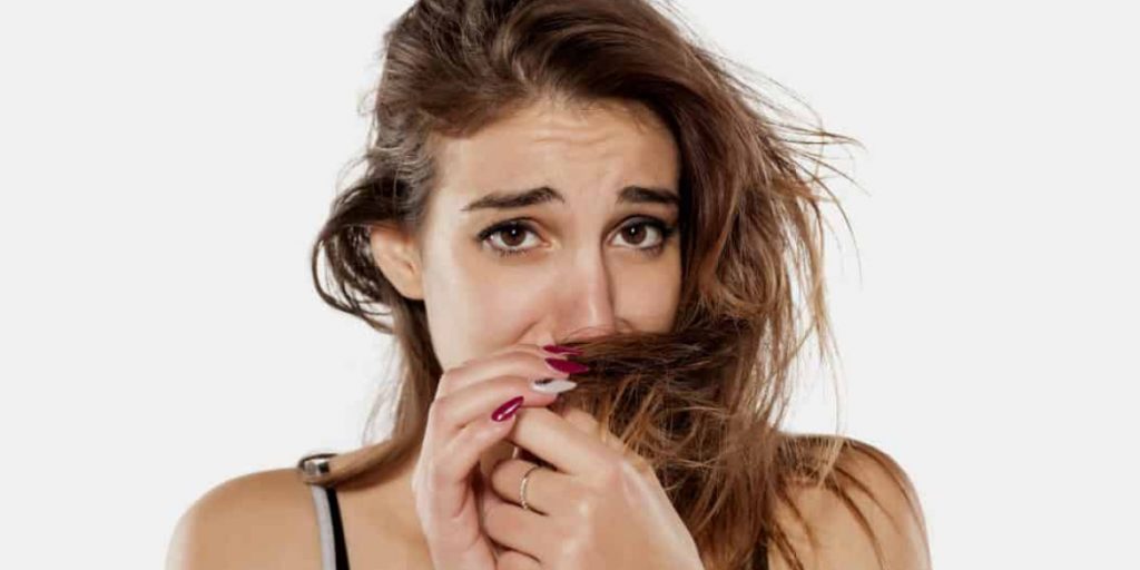 woman is sniffing her hair