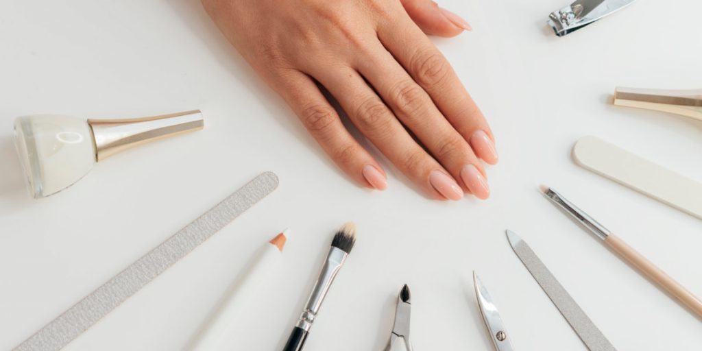 nail care tools around the woman hand