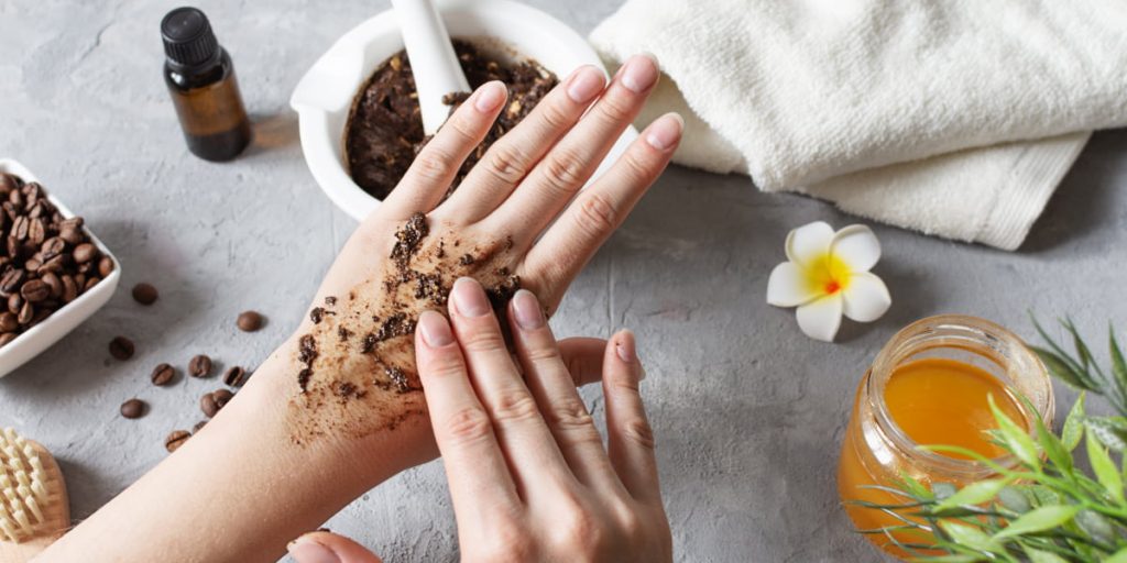 applying scrub with coffee and honey on hands