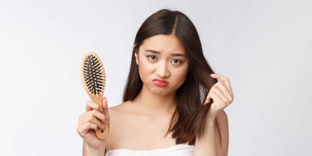 woman is holding comb looking at the camera