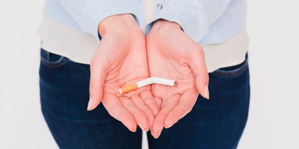 broken cigarette in woman hands