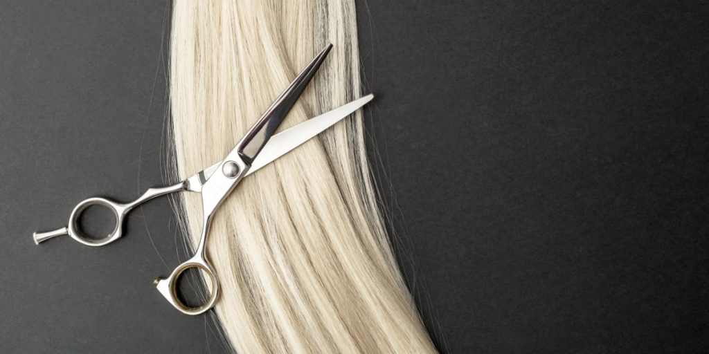 scissors lying on blond hair