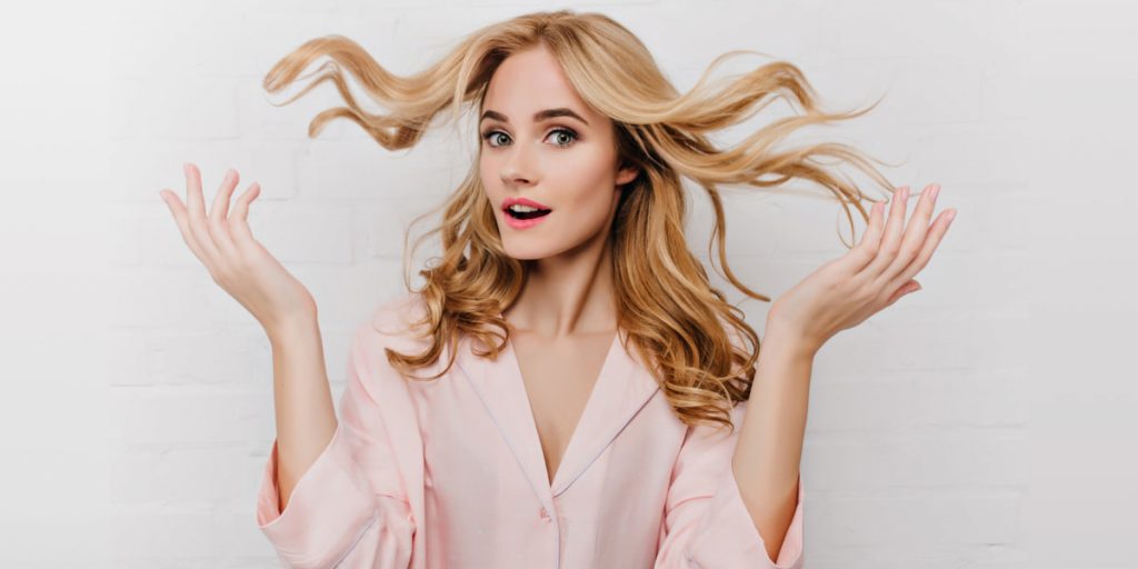 blonde girl is spreading her hair