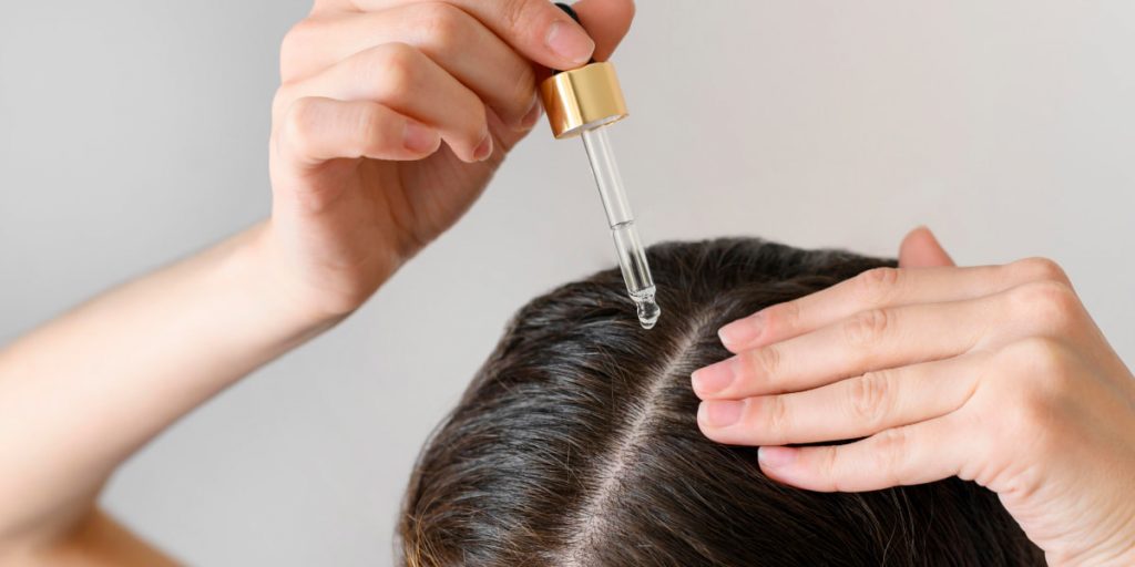 applying tree oil on scalp