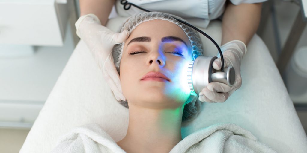 young woman gets led light therapy