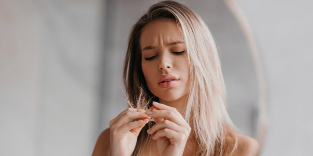 a girl is watching on hair tips