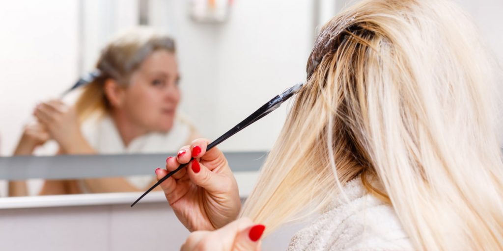 woman is bleaching hair at home