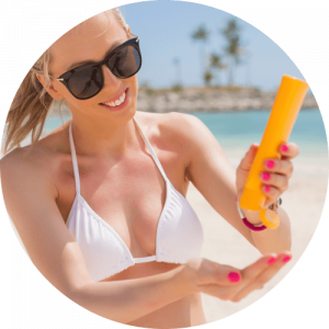 smiling woman on the beach with sunscreen