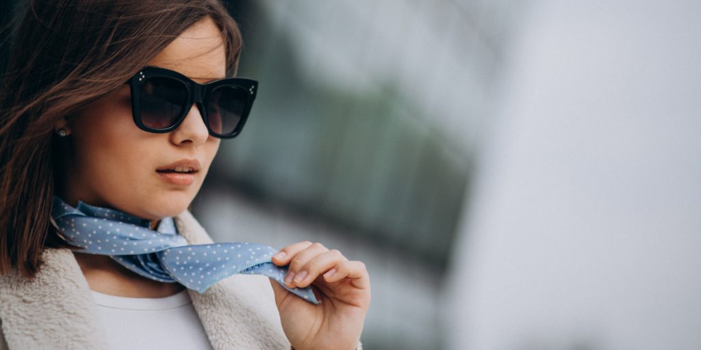 woman with sunglasses and neck scarf