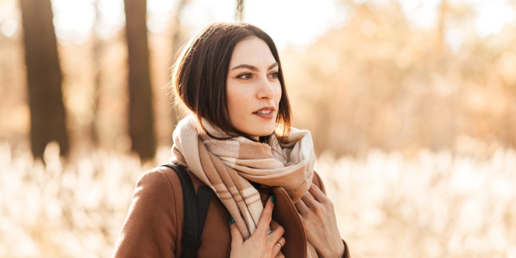 smiling woman with a neck scarf